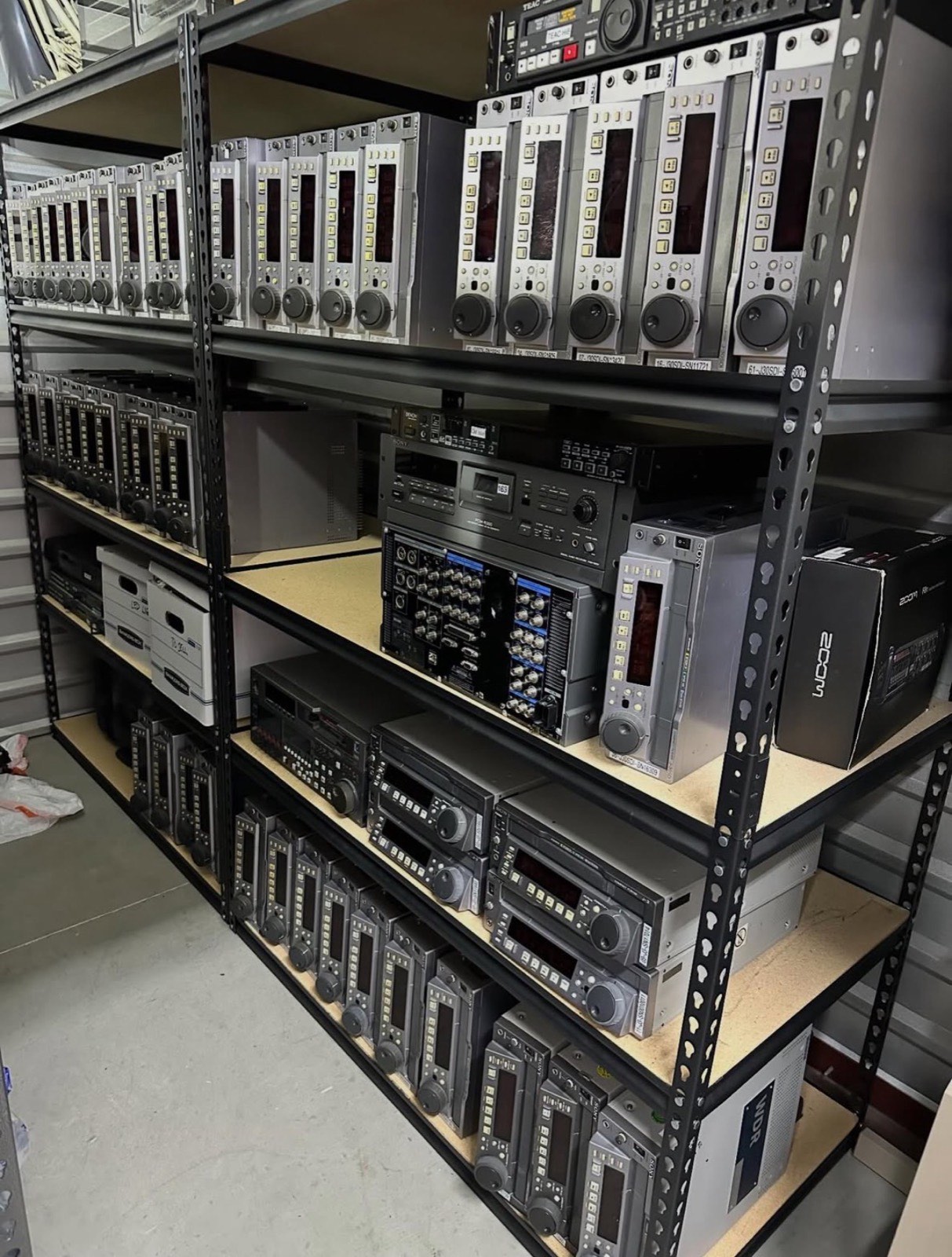 Warehouse shelves stacked with Sony broadcast videotape decks