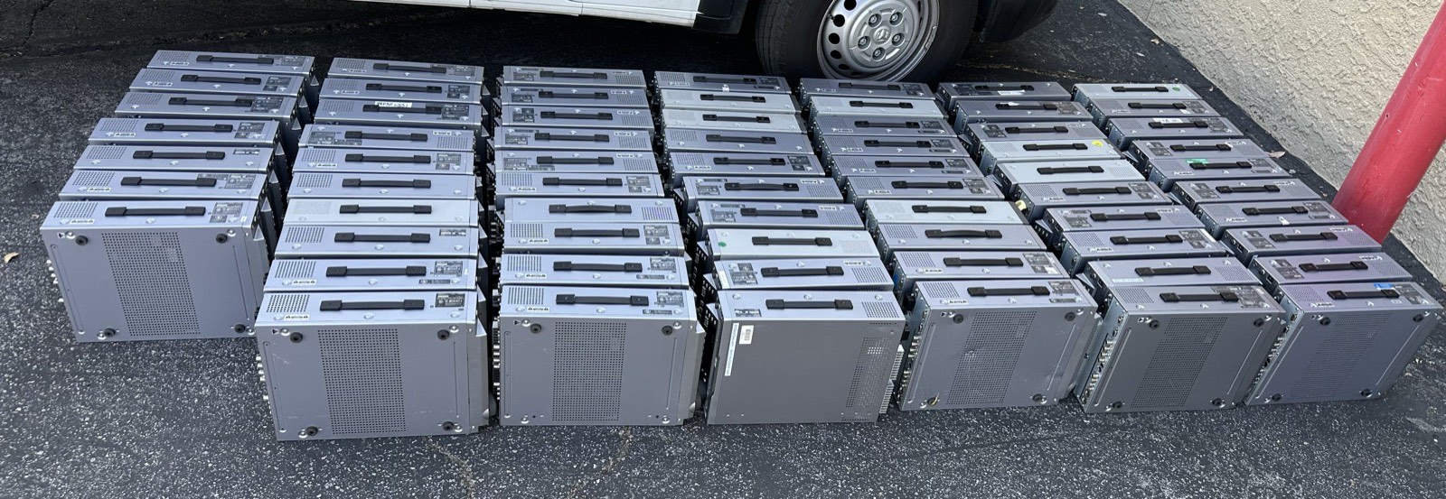 A lot of 68 Sony decks lined up on pavement